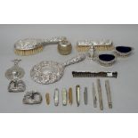 A lady's silver mounted four piece dressing set, comprising; a hairbrush, a hand mirror,