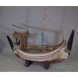 A scratch built wooden boat, early 20th century, polychrome painted over planked body,