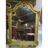 A Regency style gilt framed overmantel wall mirror with shell capped crest, 78cm wide x 116cm high.