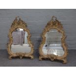 A pair of mid-19th century polychrome painted floral moulded strut mirrors,