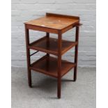 A George III "Country House" mahogany whatnot, adjustable hinged top with separate rest above tiers,