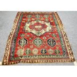 A Fachralo Kazak rug, Caucasian, the madder field with a bold ivory and madder medallion,