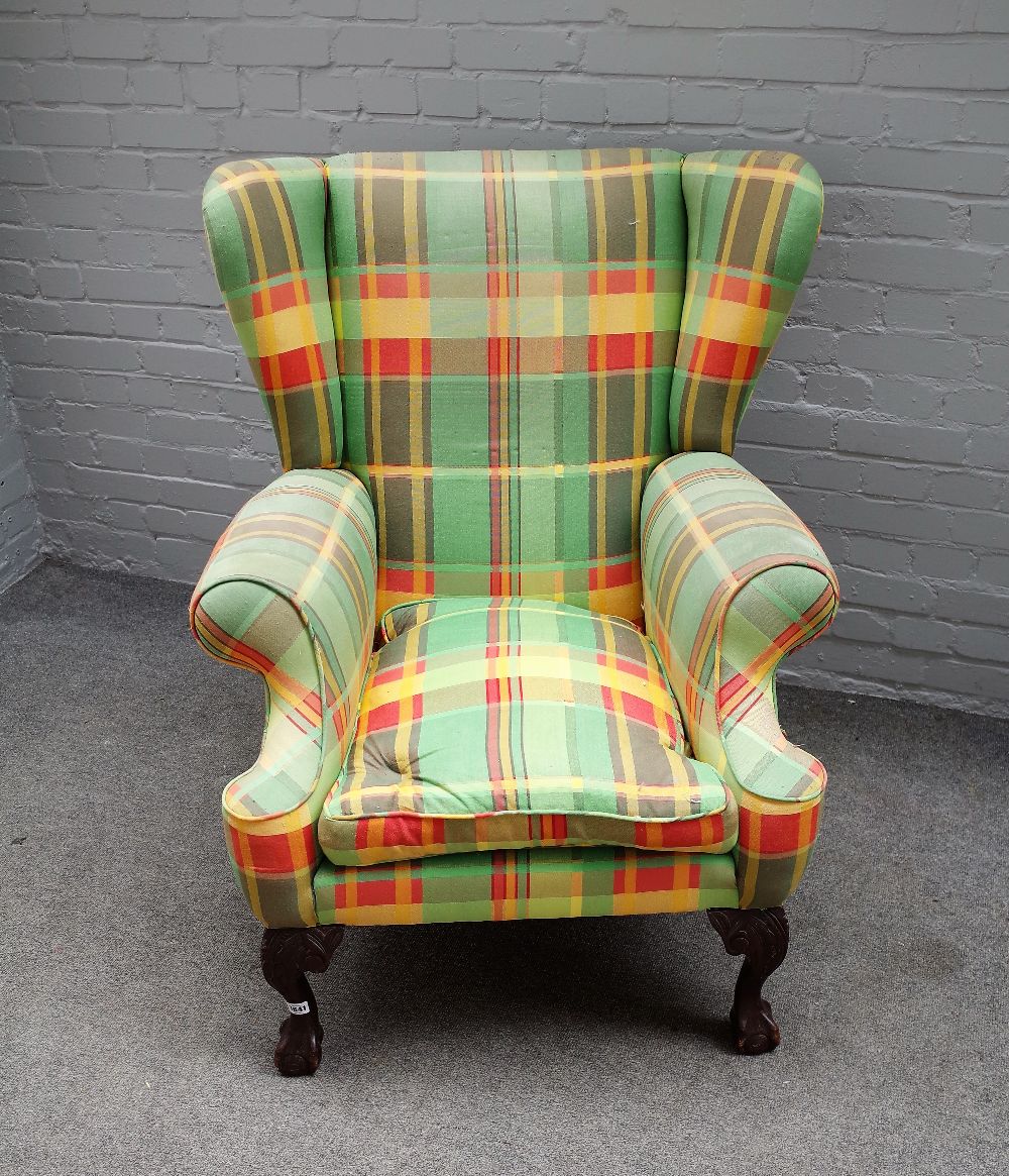 A George II style wingback armchair, on claw and ball feet, 85cm wide x 105cm high.