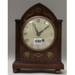 An early 19th century rosewood and brass inlaid mantel clock,