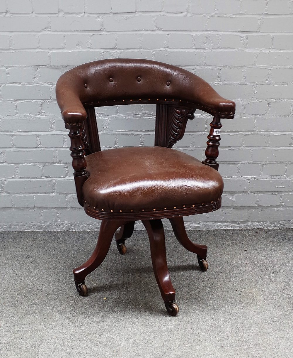 A Victorian mahogany framed tub back office swivel chair, on four downswept supports,