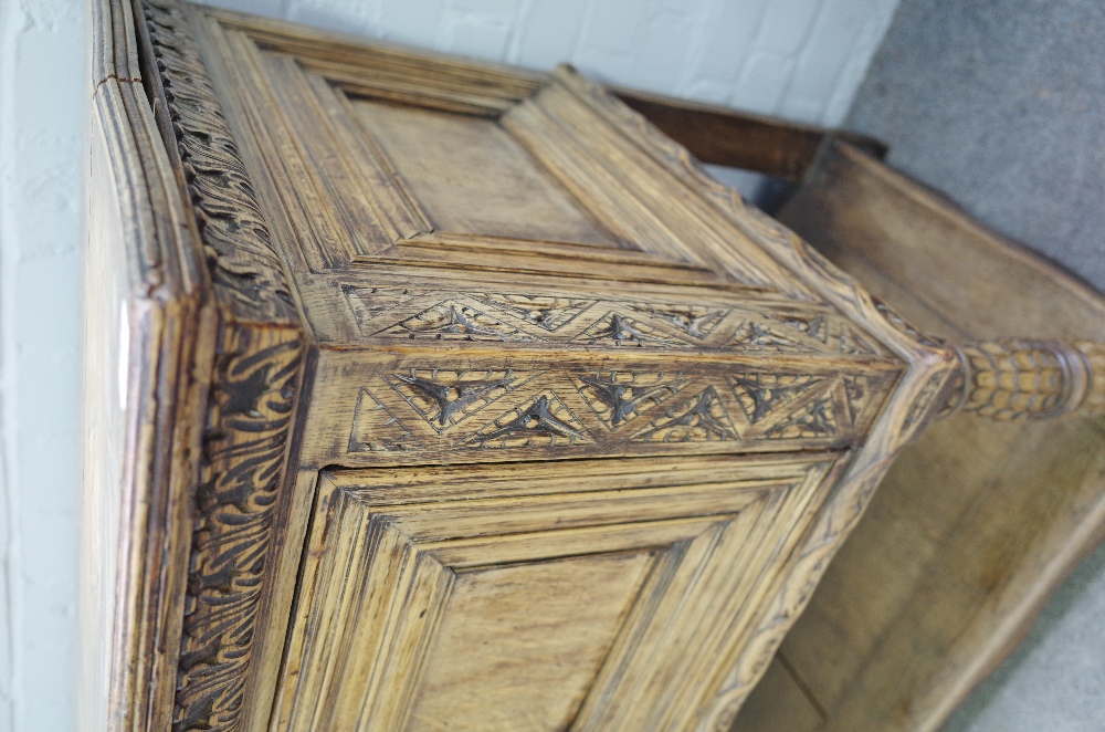 A 17th century style carved oak dresser base, with three recessed panel doors, on turned supports, - Image 5 of 5