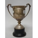 A silver twin handled trophy cup, raised on a circular foot, presentation inscribed, Sheffield 1932,