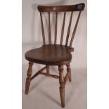 An early 20th century beech framed child's stick back chair, 61cm tall.
