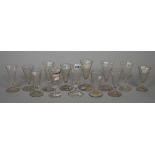 A group of thirteen dwarf ale glasses, 18th/early 19th century, some with wrythen moulded bowls,