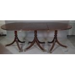 A regency style mahogany D end triple pedestal extending dining table