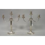 A pair of three light table candelabra, each with a curved arm,