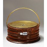 A George III ash and brass foot warmer with ribbed body and loop handle, 27cm diameter x 12cm high.