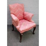 A George III style easy armchair with outswept arms of four scroll mahogany supports,
