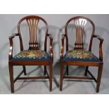 A pair of Hepplewhite design mahogany arch back carver chairs on tapering square supports,