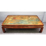 A 20th century Chinese rectangular coffee table, polychrome painted with flowers in a water garden,