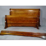 A 20th century hardwood sleigh bed, 163cm wide x 95cm high.