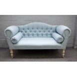 A Victorian style hump back scroll end sofa on baluster supports, 140cm wide x 71cm high.