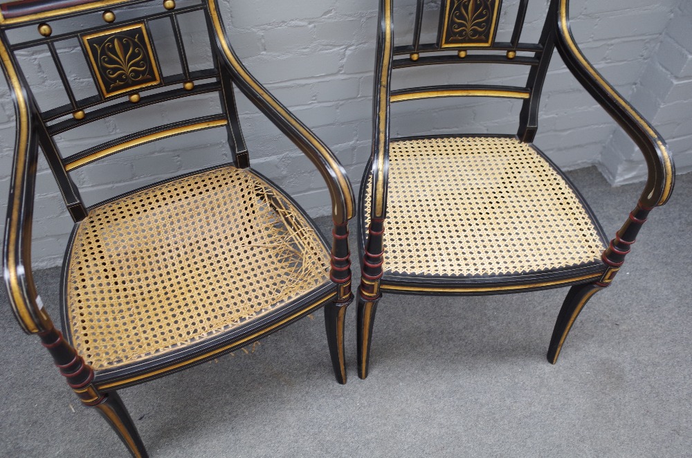 A pair of Regency style parcel gilt ebonised open armchairs on sabre supports, - Image 3 of 3