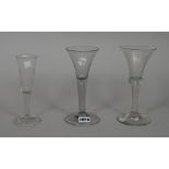 Three plain-stem wine glasses.