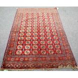 A part silk Tekke Turkman rug, the madder field with five columns of thirteen guls,