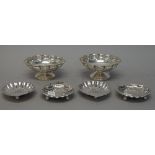 A pair of silver pedestal bonbon dishes, with pierced scalloped borders,