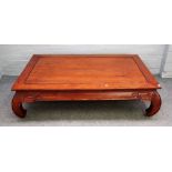A 20th century Chinese low table, the rectangular top on inswept supports, 150cm wide x 41cm high.