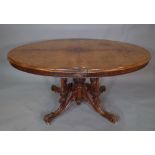 A Victorian burr walnut oval snap top dining table on four out swept support, (a.f.).