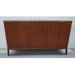 Osvaldo Borsani, (Italian, 1911-1985), a walnut credenza with red glass plate and concave front,