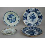 A Dutch Delft blue and white plate, 18th century, painted with a central vase of flowers, 34.5cm.