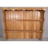 An early 20th century pine two tier plate rack, 153cm wide x 122cm high.