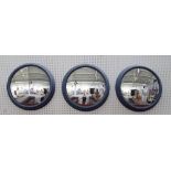 A set of three 20th century convex wall mirrors in blue painted moulded frames, 64cm diameter.