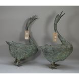 A pair of modern verdigris patinated bronze ducks, 66cm high, (a.f.), (2).