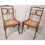 A set of four Regency faux rosewood side chairs on sabre supports, (4).