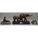 A modern elephant group, on a polished black granite plinth (33cm wide),