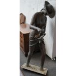 A modern bronzed metal female figure depicted paddling,