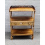 A Victorian rosewood three tier whatnot, with single drawer on barleytwist supports,