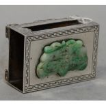 A silver matchbook slide, of rectangular form, the cover applied with a jadeite plaque,