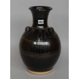 A large vase with three handles, decorated with pattern under tenmoku glaze, makers mark, 38cm high.