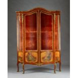 A late 19th century French gilt metal mounted mahogany serpentine framed vitrine,