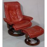 A contemporary swivel back leather upholstered easy chair, with matching footstool, (2).