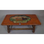 A 20th century Chinese hardwood low table, decorated with deer, 88cm wide x 29cm high.
