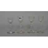 Four engraved facet-stemmed wine glasses, late 18th,