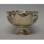 A Chinese bowl, the body decorated with floral sprays within a shaped rim, presentation inscribed,