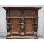 An oak overmantel incorporating 17th century elements, the two arched panels divided by figures,