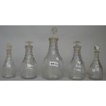 Five Prussian shaped decanters, early 19th each cut with flutes at the shoulders beneath ring necks,