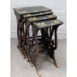 A Victorian nest of four parcel gilt papier-mâché occasional tables on pierced trestle supports,