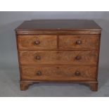 A George III style oak chest of two short and two long drawers on bracket feet,
