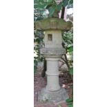 A Japanese carved stone garden lantern, 19th/20th century, on pedestal, 183cms high.