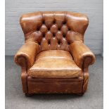 Ralph Lauren; a 20th century brown leather upholstered easy armchair on bun feet,