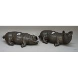 A pair of modern bronzed lead pigs, each recumbent, initialled to the base, 38cm wide, (2).